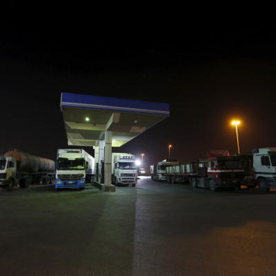 Trucks wait for fuel pumps to reopen after morning prayers, during early hours at a petrol station in Khobar, west of Riyadh