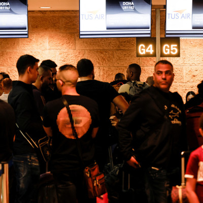 Football fans queue before boarding the first direct commercial flight between Israel and Qatar for the upcoming 2022 FIFA World Cup Qatar, at Ben Gurion International Airport, near Tel Aviv
