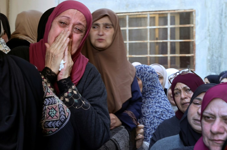 Palestinian mourners cry during the funeral of militant Muhammad Ayman al-Saadi, 26