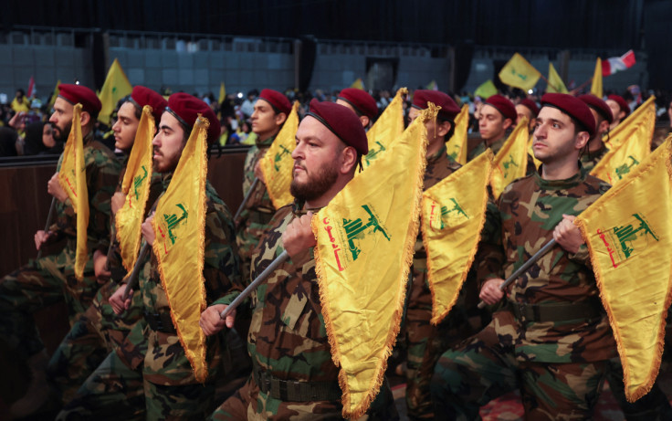 Members of Lebanon's Hezbollah hold flags during a rally commemorating the annual Hezbollah Martyrs' Day in Beirut's southern suburbs