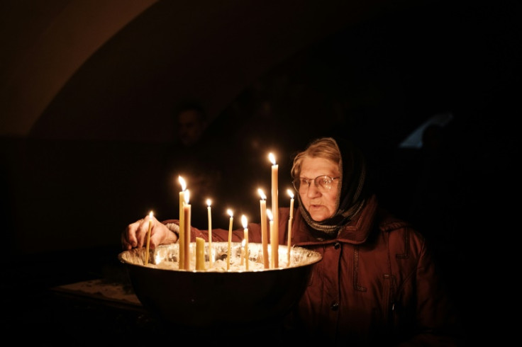 The sound of shelling verberates in the even of the basement of the Orthodox All Saints' Church in Bakhmut
