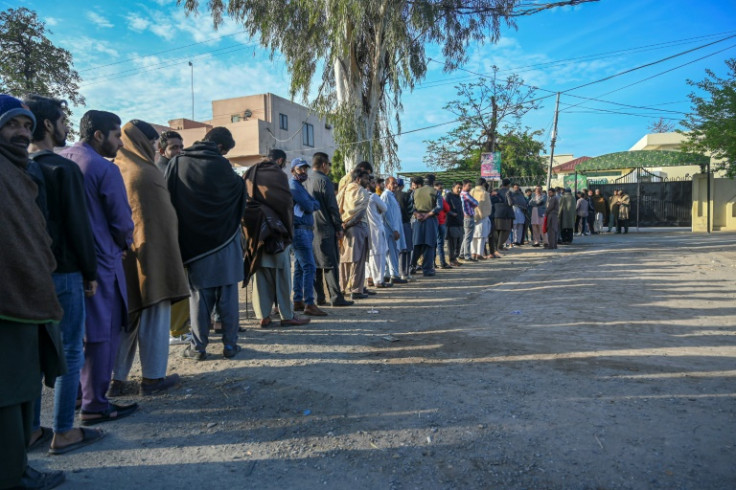 People queue outside the passport office in Gujrat district