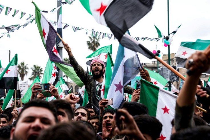 Syrian opposition supporters rally in rebel-held Idlib on the 12th anniversary of the uprising against President Bashar al-Assad