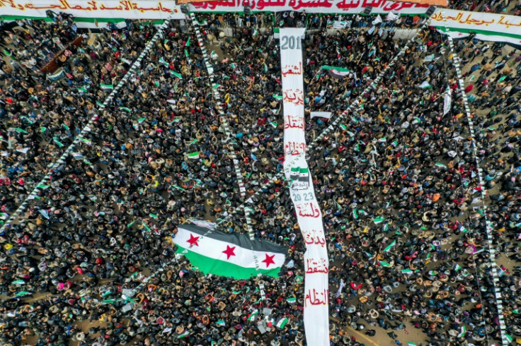 Demonstrators carried a giant Syrian opposition flag to mark the anniversary