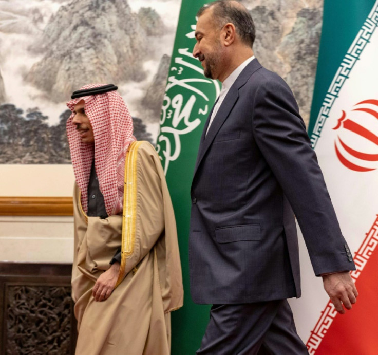 Saudi Foreign Affairs Minister Prince Faisal bin Farhan, on the left, walks with Iran's Foreign Minister Hossein Amir-Abdollahian in Beijing on April 6, 2023, in a picture released by the Saudi Press Agency