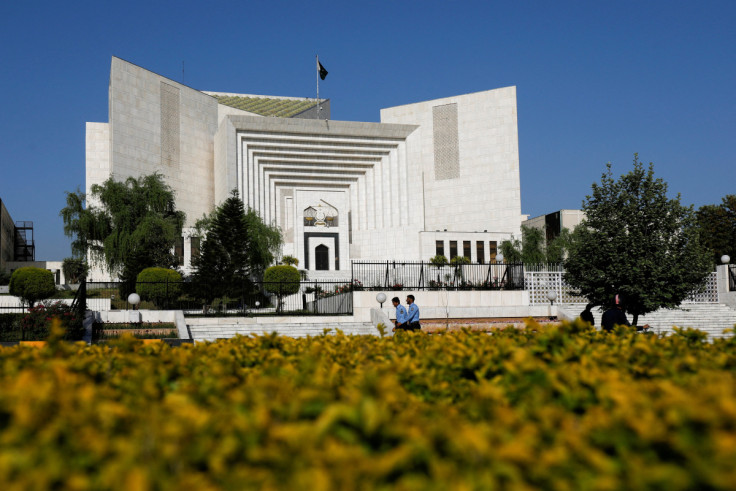 Police officers walk past the Supreme Court of Pakistan building, in Islamabad,