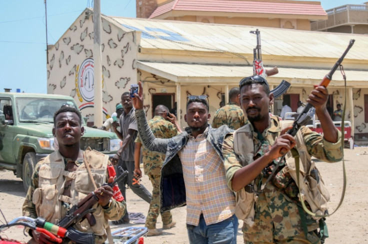 Soldiers loyal to Sudan's army chief Abdel Fattah al-Burhan pose for a picture at the Rapid Support Forces (RSF) base in the Red Sea city of Port Sudan on April 16