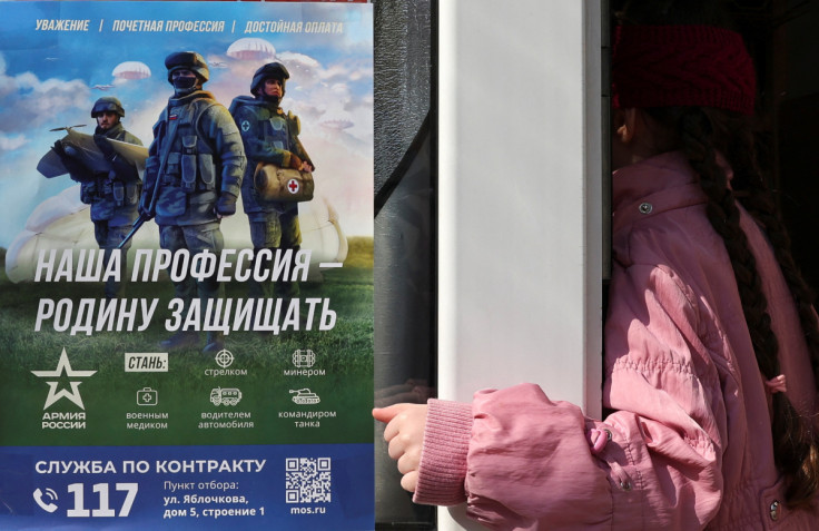 A customer enters a shop with a poster promoting Russian army service in Moscow