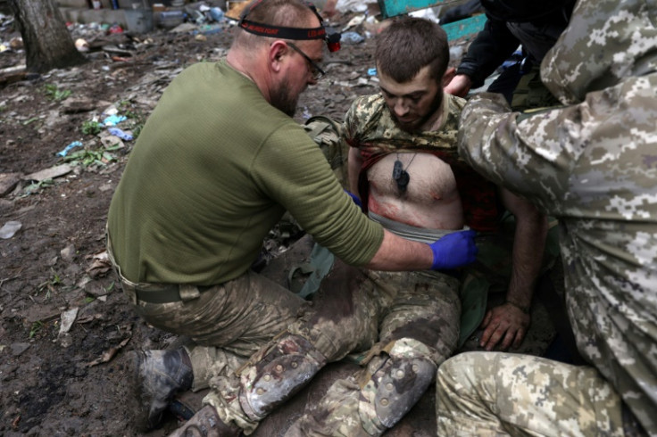 Military paramedics treat an Ukrainian injured serviceman in Bakhmut