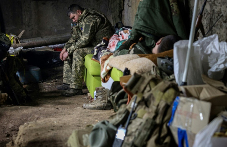 A Ukrainian servicemen rests in a basement at the frontline in the city of Bakhmut