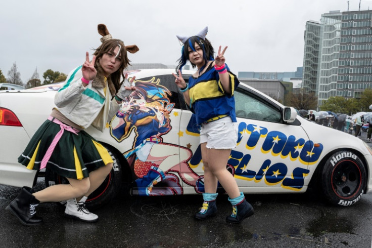 Cosplayers pose for a photo during the Odaiba Itasha Heaven 2023 festival in Tokyo