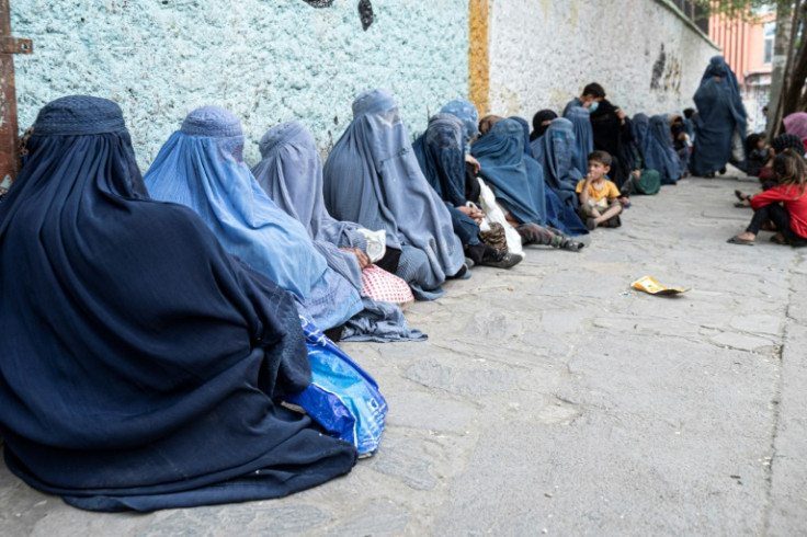 Afghan women wait to collect bread from a charity during in Kabul. The UN Security Council said the Taliban government's policies on women undermine human rights