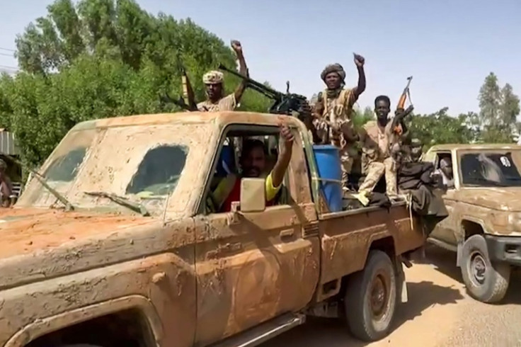 Sudanese paramilitary Rapid Support Forces (RSF) ride in the back of a pickup truck mounted with a turret