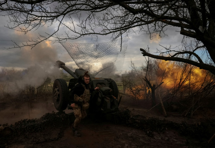Ukrainian service members fire a howitzer D30 at a front line near the city of Bakhmut