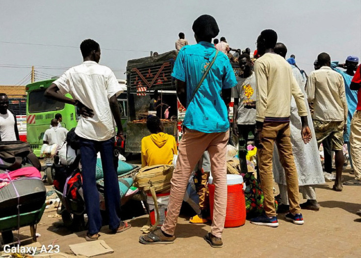 People gather to ride trucks to flee outside Khartoum, in South Khartoum locality