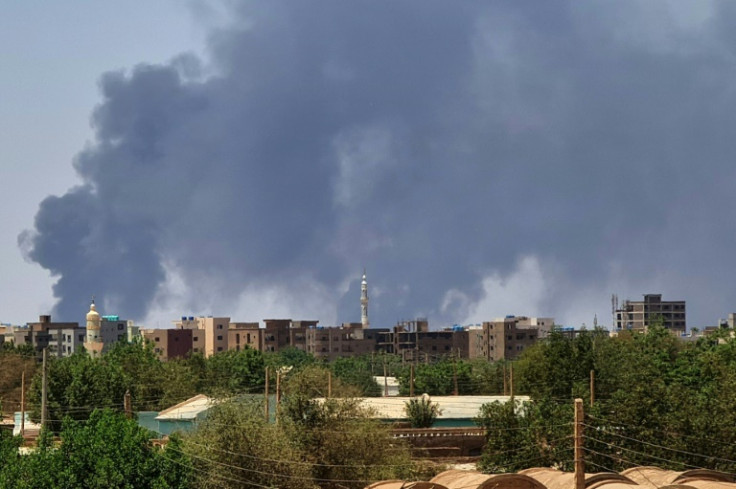 Smoke billows over buildings in Khartoum during the third week of battles between rival generals