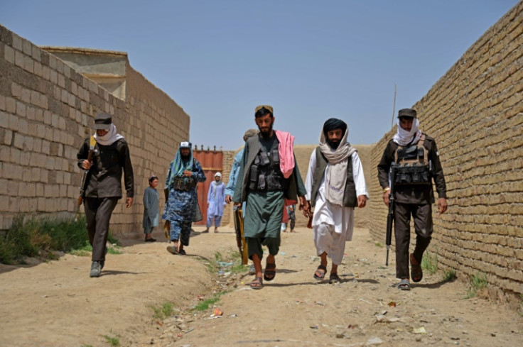 Taliban security personnel arrive to destroy a poppy plantation in Sher Surkh village in Kandahar province