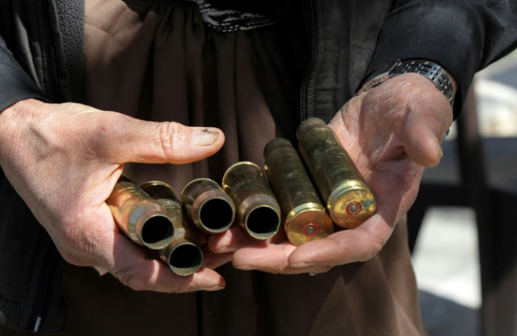 Moustafa Ahmed shows bullet casings collected after one of the many firefights near his home