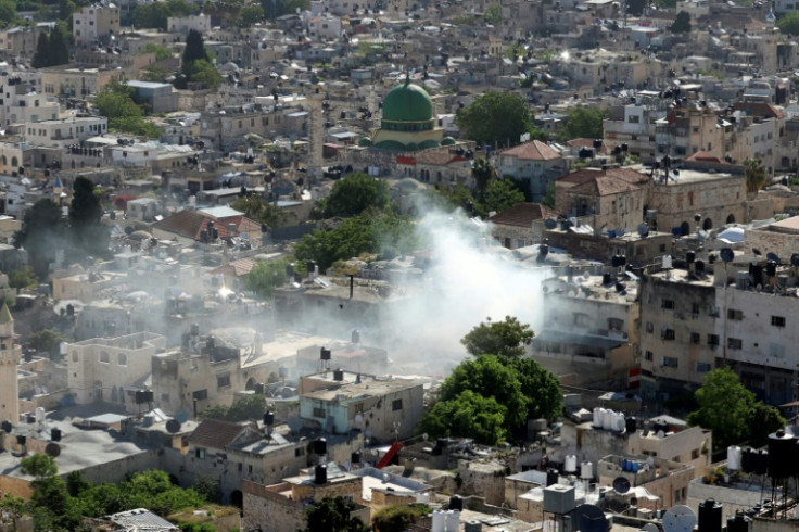 Smoke rises over the West Bank city of Nablus as Israeli troops carry out a deadly raid in the Old City