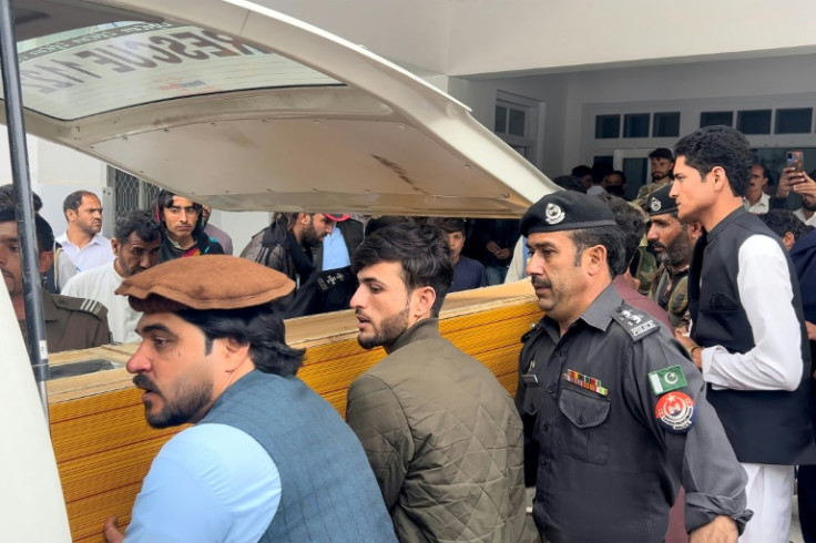 The coffin of a teacher killed in a school attack in Pakistan is taken from hospital for burial