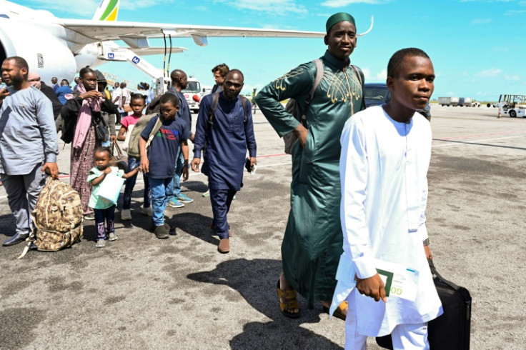 Ivorian nationals who were evacuated from Sudan disembark from a plane at Felix Houphouet Boigny International airport near Abidjan