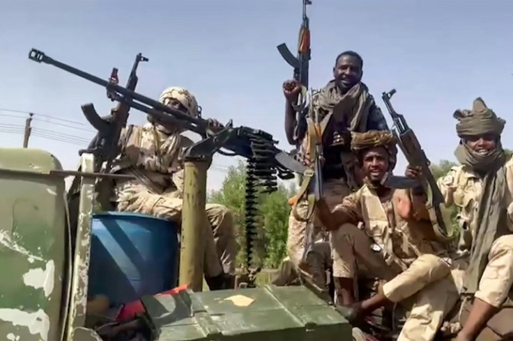 A file picture fighters from the paramilitary Rapid Support Forces riding on the back of a heavily armed pickup truck in Port Sudan