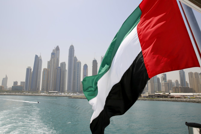 UAE flag flies over a boat at Dubai Marina