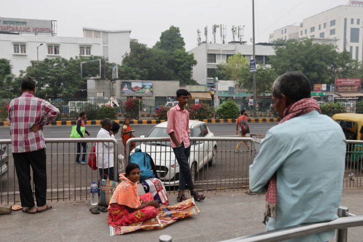 Mithilesh Chaudhary looks on as his mother and his grandfather wait to get an appointment outside All India Institute of Medical Sciences (AIIMS), in New Delhi