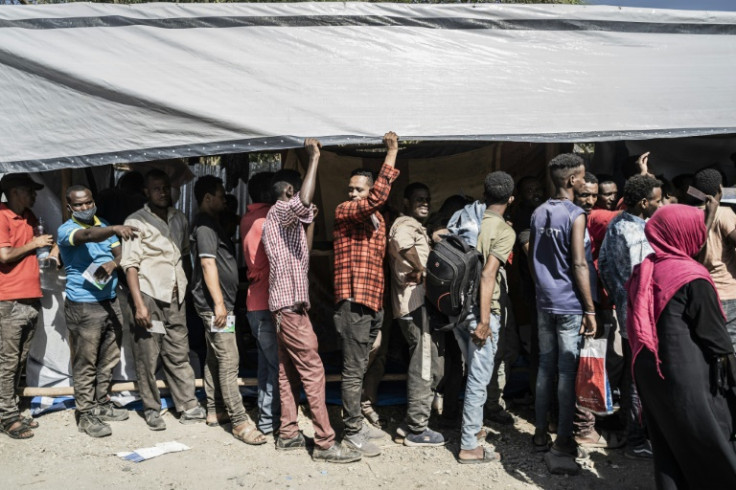 Refugees who crossed from Sudan to Ethiopia wait in line to register with the International Organization for Migration in Metema