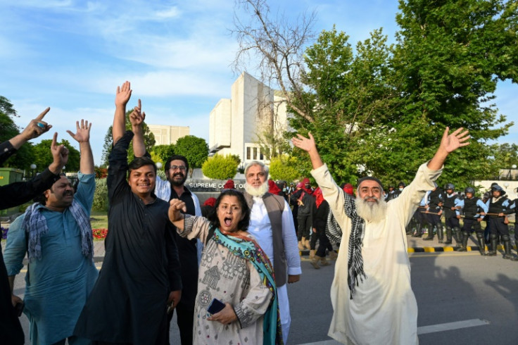 Supporters of Imran Khan's Pakistan Tehreek-e-Insaf (PTI) party chant slogans outside the Supreme Court during the ex-prime minister's hearing