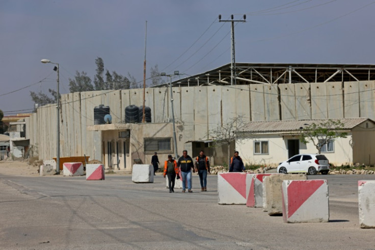 Palestinians walk at the Kerem Shalom border crossing in Rafah as Israel gradually reopens Gaza crossings