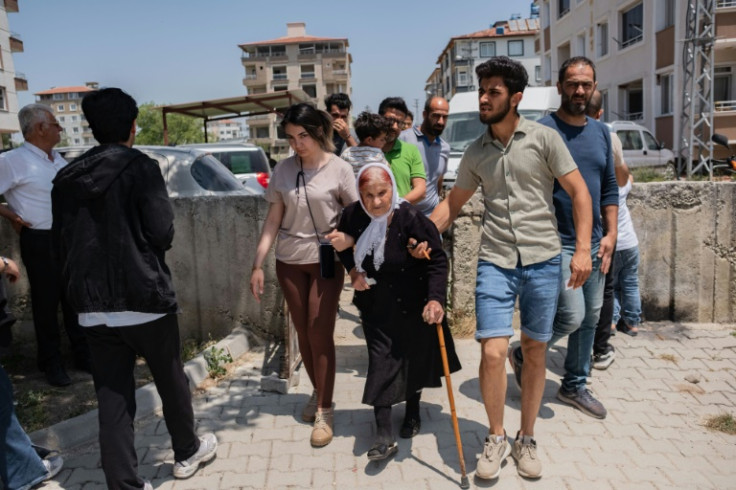 People arrive to vote in the presidential and parliamentary elections in the southern Turkish city of Antakya, destroyed by this year's devastating earthquake