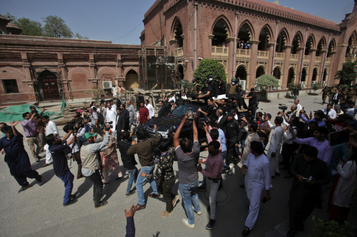 Members of media film the vehicle carrying Pakistan's former PM Khan and his wife Bushra Bibi at the High Court in Lahore