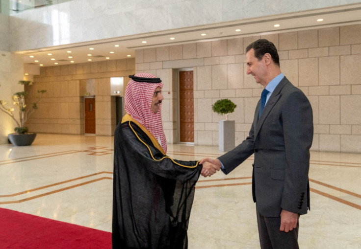 Syria's President Bashar al-Assad shakes hands with Saudi Foreign Minister Prince Faisal bin Farhan, in Damascus