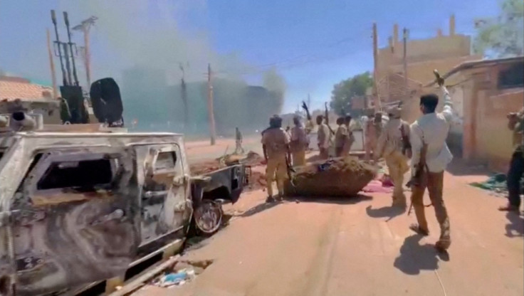 RSF fighters stand near the damaged Air Defence Forces command centre in Khartoum