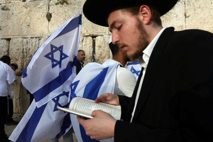 Ultra-Orthodox Jewish men pray at the Western Wall in the Old City of Jerusalem during the Israeli 'flags march' to mark "Jerusalem Day" on May 18 Jerusalem police and residents are bracing for extremist ministers and their supporters to rally on May 18 i