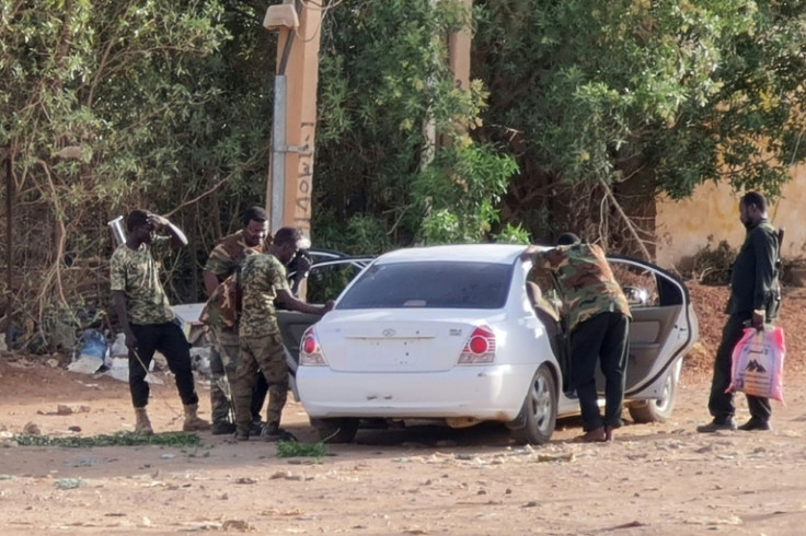 Fighter loyal to the regular army search a car without a licence plate in the Sudanese capital Khartoum