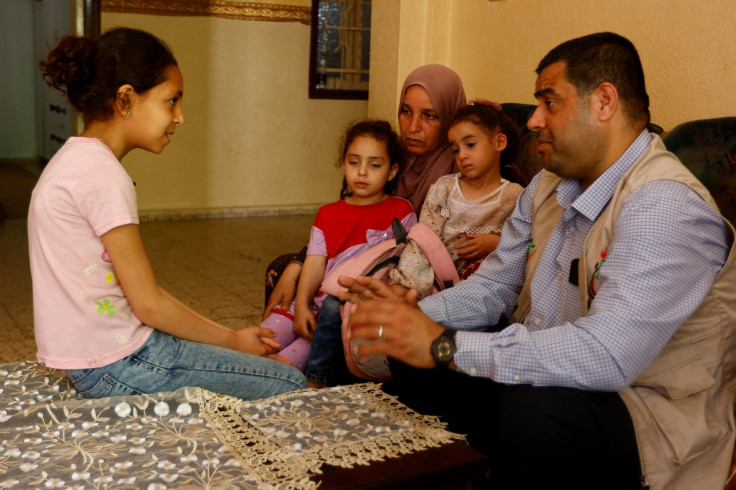 Palestinian girl Bissan al-Mansi speaks to a psychiatrist at her house in Deir al-Balah,