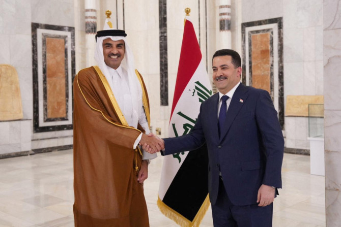 Iraqi PM Mohammed Shia al-Sudani shakes hands with Qatar's Emir Sheikh Tamim bin Hamad al-Thani during a welcome ceremony, in Baghdad
