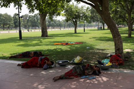 Women labourers rest under a tree on a hot summer day in New Delhi