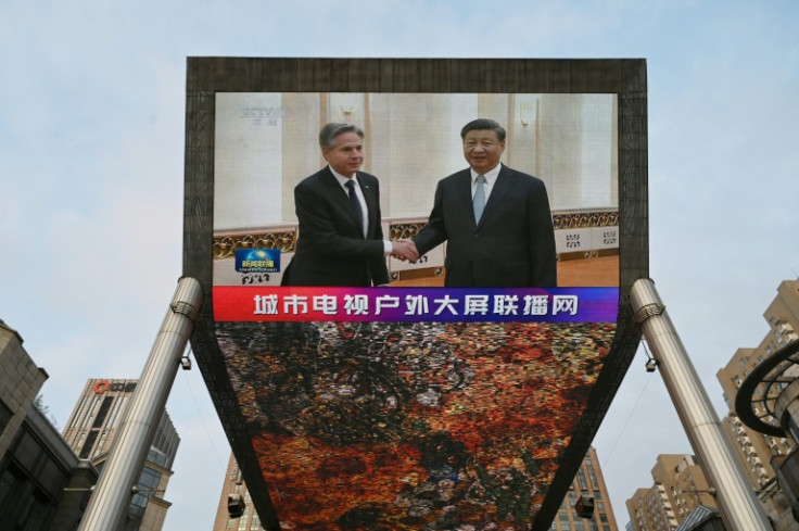 A China Central Television news broadcast on a screen outside a Beijing shopping mall shows US Secretary of State Antony Blinken meeting with China's President Xi Jinping