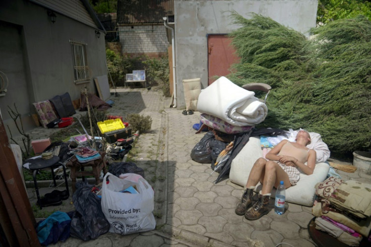 A local resident taking a rest, surrounded by whatever could be salvaged