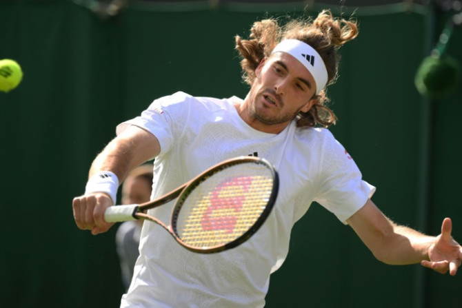 Stefanos Tsitsipas in action against Dominic Thiem in the Wimbledon first round