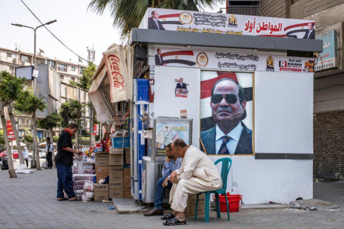 Portraits of Egypt's President Abdel Fattah al-Sisi adorn a stall in central Cairo for the government-sponsored "Citizen First" initiative, which aims to sell basic goods at reduced prices