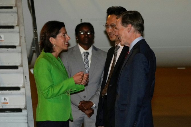 US Secretary of Commerce Gina Raimondo, (L) speaks with Lin Feng, director general of China, ministry of commerce, (2R), and US Ambassador to China Nick Burns, (R) upon arrival at the Beijing capital International Airport in Beijing, on August 27, 2023.