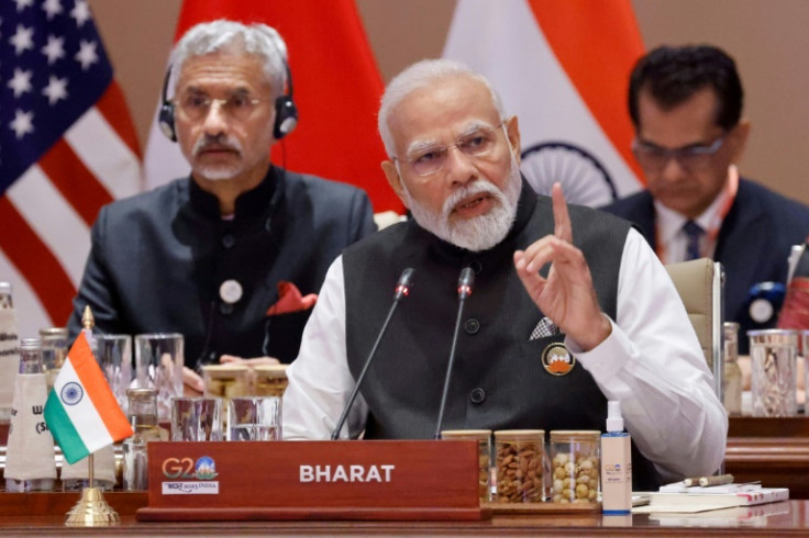 India's Prime Minister Narendra Modi (C) has used the G20 presidency to burnish his image at home and abroad