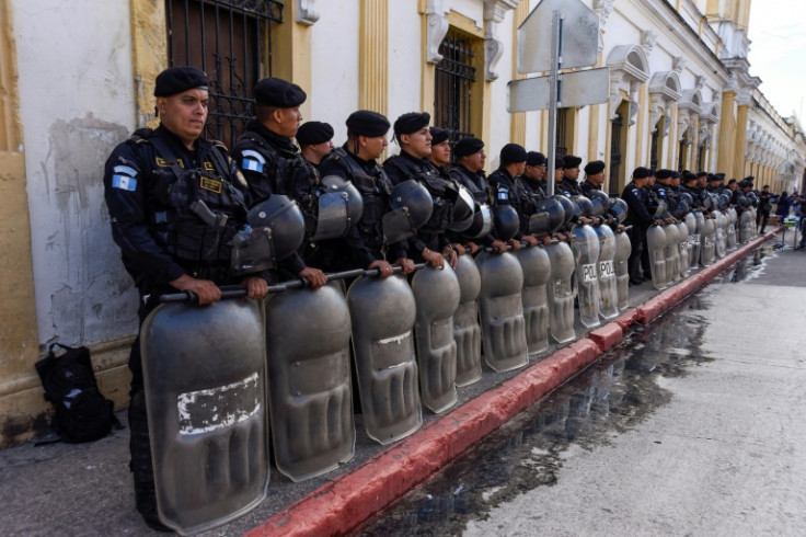 Riot police stand guard outside the Guatemalan Congress in Guatemala City on November 16, 2023