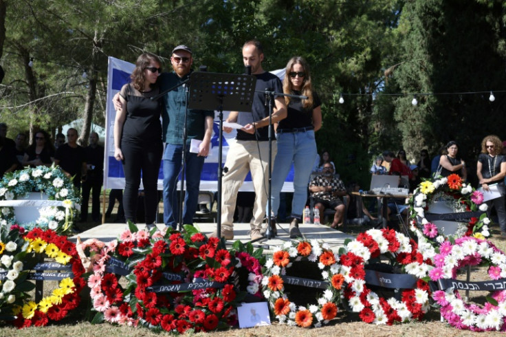 Family members speak during the memorial