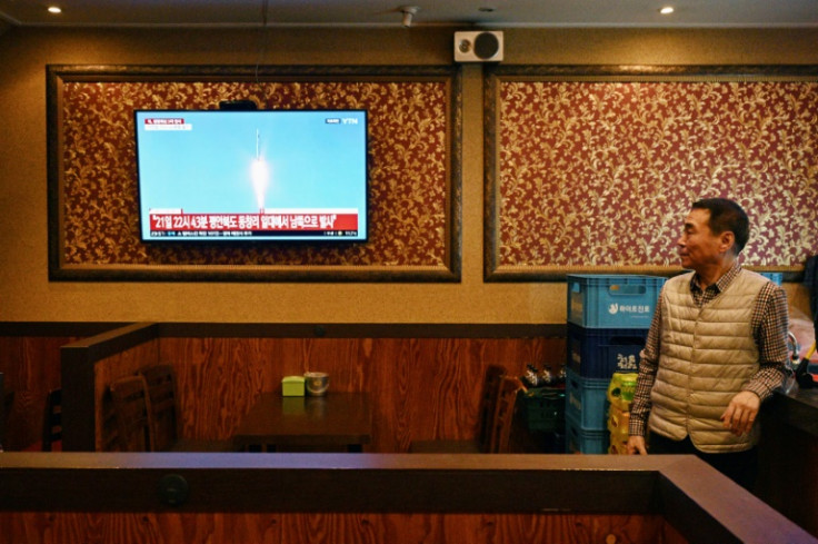 A man watches a television showing a news broadcast at a restaurant in Seoul late Tuesday