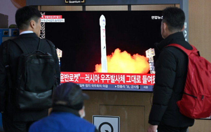People watch a news broadcast showing North Korea's satellite launch at a railway station in Seoul on Wednesday